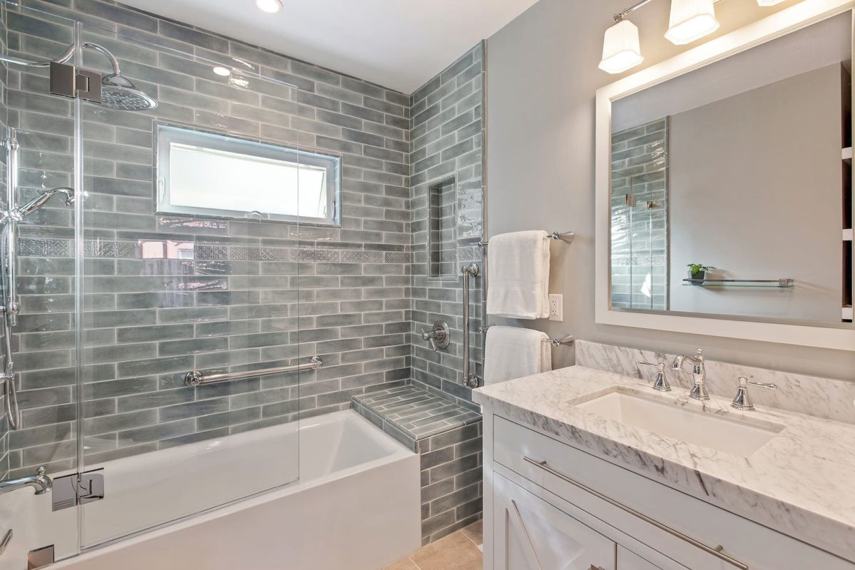 Updated grey tile bathroom with shower bath combo.